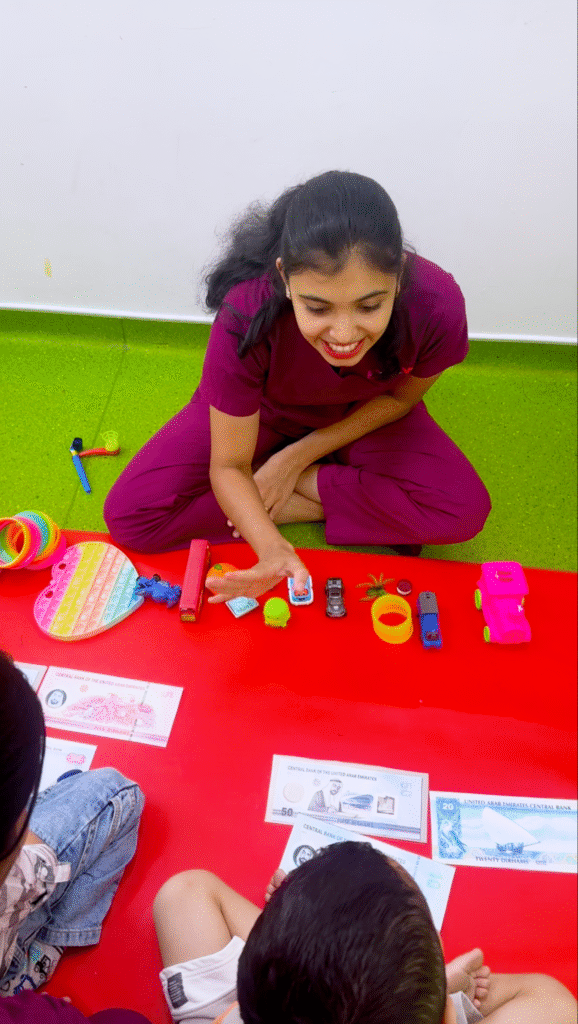 A speech therapist conducting a playful language session with children using toys and visual aids.